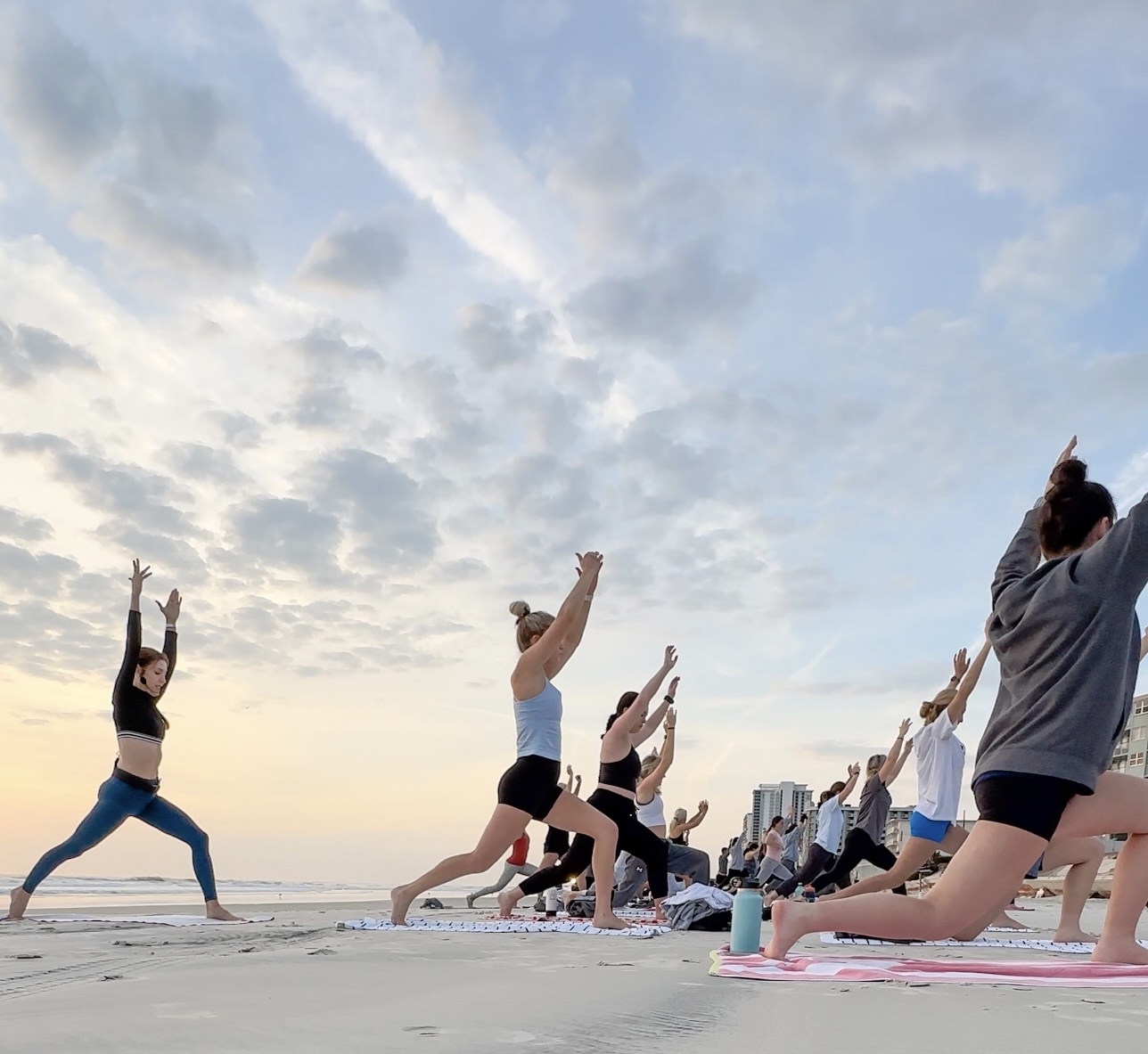 Sherri Meyers leads the Merrimack College Women's Lacrosse Team in a yoga class on the beach in Daytona Beach at sunrise.