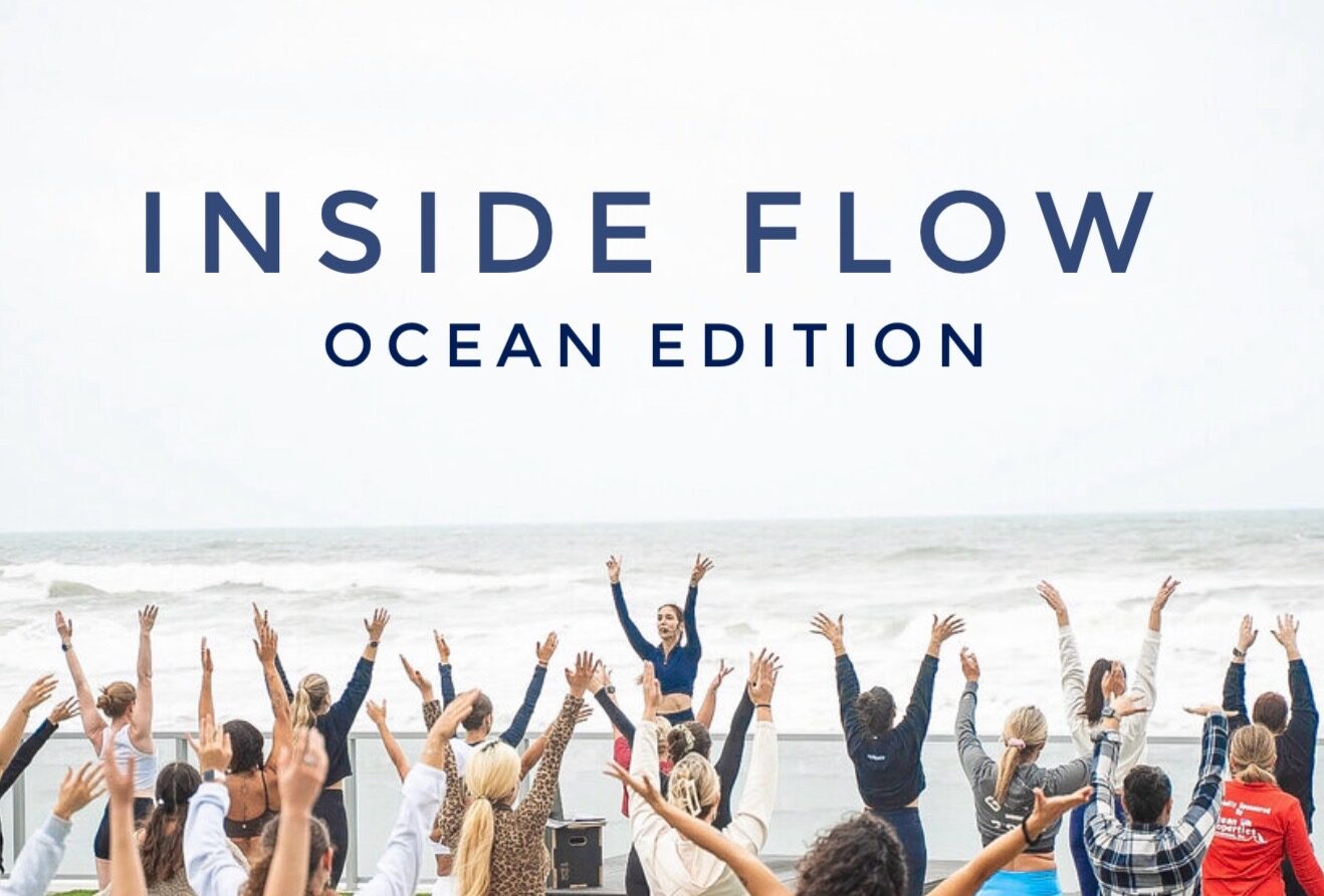 A group of people practice yoga outdoors near the ocean, following an instructor at the front. The words “Inside Flow Ocean Edition” appear at the top. The group is led by Sherri Meyers of Studio 311 Yoga & Fitness in Daytona Beach, FL